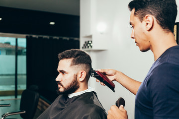 Client during beard and hair grooming in barber shop