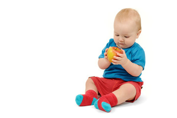 Fototapeta na wymiar Baby boy with an apple on white background