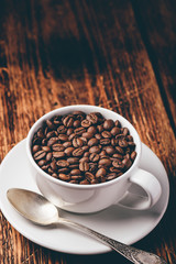 Cup full of roasted coffee beans