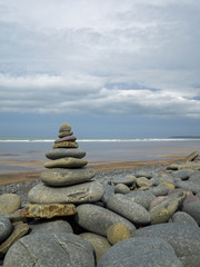 Fototapeta na wymiar Holistic stone stack on the beach at Westward Ho! in Devon