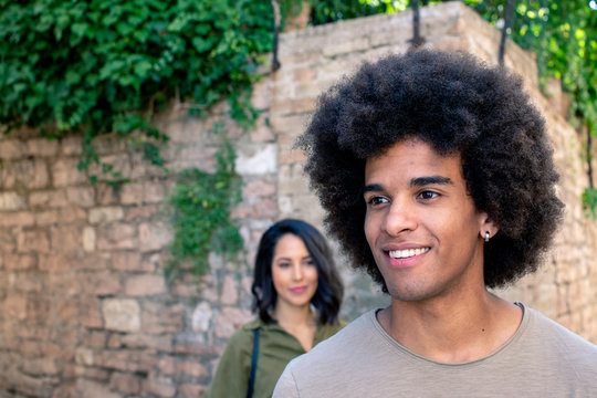 Smiling young couple standing outdoors