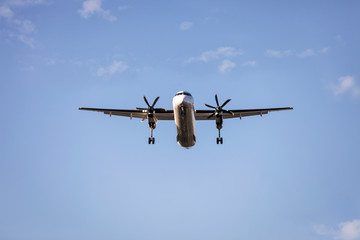 Flying passenger Airplane preparing to land