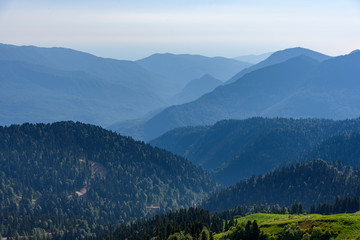 Silhouette of mountains at sunset. Mountain forest in the valley