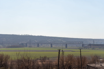 Fototapeta premium Railway bridge on the background of mountains and green fields