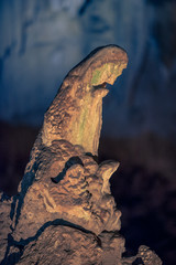 Fototapeta na wymiar An illuminated stalagmite formation resembling the Mother Mary praying, at the Wondercave in South Africa, near Johannesburg