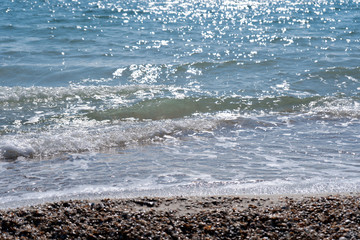 Sand-shell beach and blue sea waves on a summer vacation - a cure for the soul