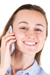 portrait closeup of young smiling woman with mobile phone looking up