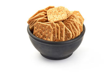 Crispy salted crackers biscuits, close-up, isolated on white background