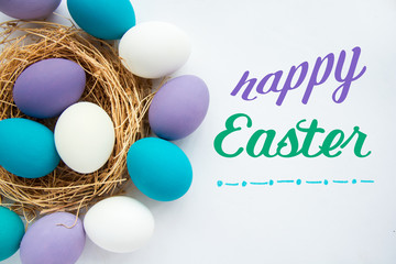 soft shades of purple and blue Easter eggs in the nest. happy easter wishes card  