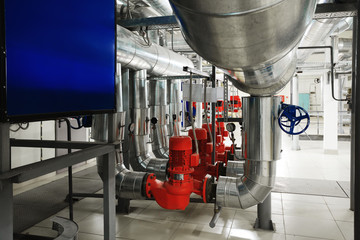 boiler room with pumps and pipe lines supplying steam with pressure gauges installed
