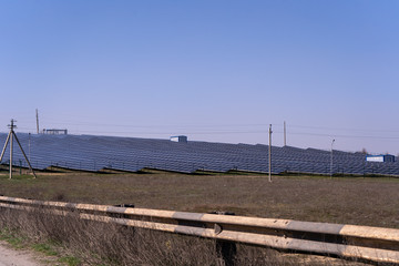 Fototapeta premium Plenty of solar panels in the field, cloudless blue sky