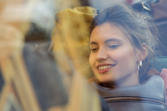 Smiling woman sitting in car