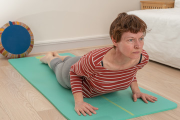 Fototapeta na wymiar Paris, France - 03 24 2019: woman doing yoga at home
