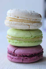 Colorful French or Italian macaroon stack cakes / Macaroon cakes. Assorted macaroon cakes stacked on top of each other on a light background. Copy space. Delicious dessert.