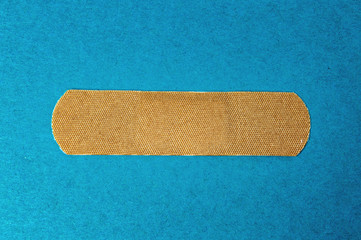 medical sticker, patch of textile on a blue background close-up