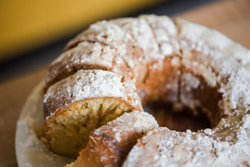 Sliced homemade cake with powdered sugar