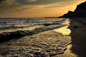 beautiful sunset, sea landscape, sea coast with high hills, wild nature