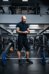 Fototapeta na wymiar Muscular athlete prepares to takes weight in gym