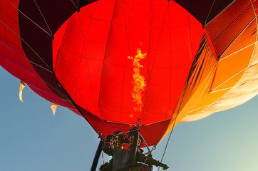 Red hot air balloon against the blue sky