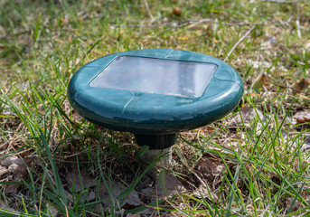 Sonic solar powered mole, rodent repeller set in the garden.