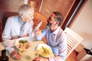 Portrait of mature couple eating healthy food at home
