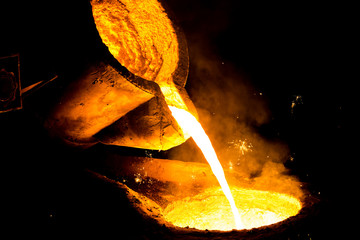 metal casting process with red high temperature fire in metal part factory