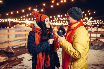Winter evening, love couple walking outdoors