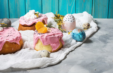Easter composition with orthodox sweet bread, kulich and eggs on concrete background