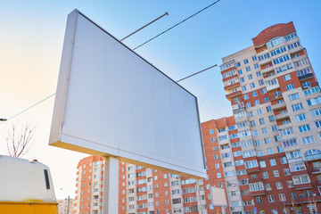 3x6 billboard big standing in the city against the sky during the daytime, with a white advertising space mockup