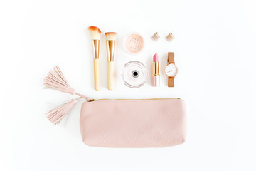 Flat lay composition with pink cosmetic bag with makeup products, isolated on white background. Flat lay, top view.