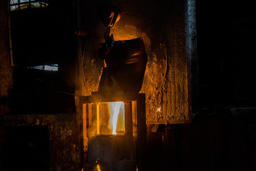metal casting process with red high temperature fire in metal part factory