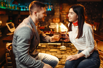 Love couple relaxing with alcohol at bar counter