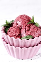 berry ice cream sherbet balls with mint in a beautiful ice-cream bowl. ice cream from  currants, strawberries, raspberries with berries. copy space.