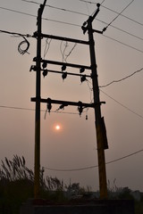 silhouette electric pole and the sun background 