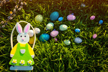 Happy Easter. Easter eggs hidden in spring grass. Basket bunny shaped. Holiday decoration