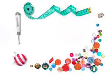 Background from Set of buttons of different color and the size are complemented with a measuring tape, a knife for unripping, a needle case on a white background. Place for inscription