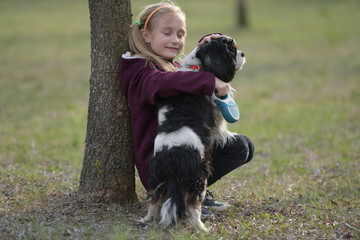 Naklejka na ściany i meble happy child girl with her dog