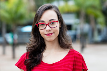 Smiling young french woman with glasses