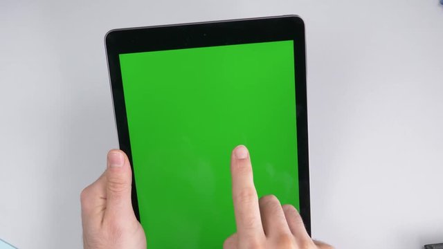 Using a tablet with a green screen display. Top view