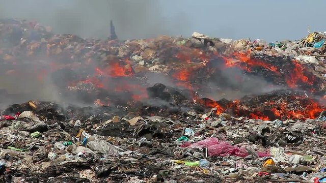 Burning garbage dump pollution, landfill near the city