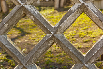 diamond shaped concrete fence close-up on a dark background. structure background