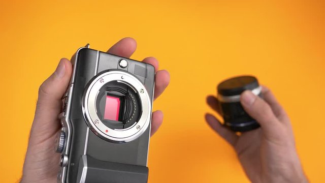 Changing the lens on an interchangeable lens camera. Top view