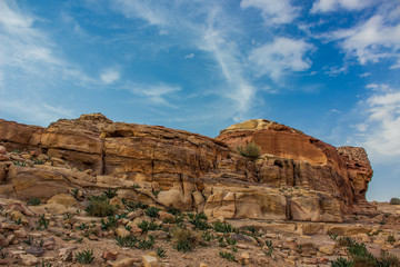 Fototapeta premium picturesque sand stone rocky wilderness outdoor environment of bare mountain ridge in colorful contrast photography from Middle East Jordan country desert