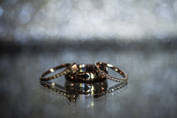 Wedding Rings on a mirror with sparkling background