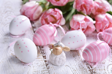easter decoration with painted eggs and pink tulips