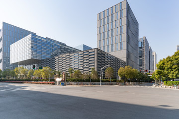 Fototapeta na wymiar Modern business office buildings with empty road, empty concrete square floor