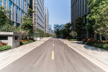 Modern business office buildings with empty road, empty concrete square floor