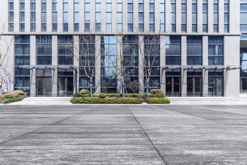 Fototapeta na wymiar Modern business office buildings with empty road, empty concrete square floor