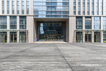 Modern business office buildings with empty road, empty concrete square floor