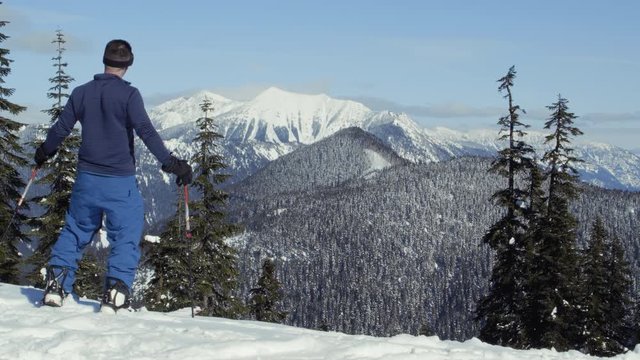 Split Board Snow Hiker with Poles Enjoys Scenic Mountain View
